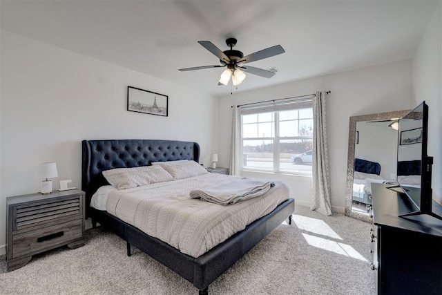 bedroom with baseboards, a ceiling fan, and light colored carpet