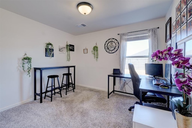 carpeted office space featuring a healthy amount of sunlight, visible vents, and baseboards