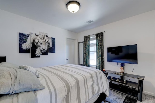 bedroom with carpet flooring, visible vents, and baseboards