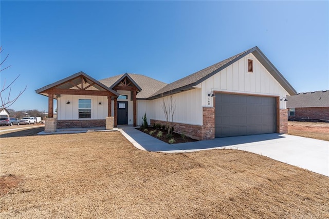 modern farmhouse style home with brick siding, board and batten siding, concrete driveway, a front yard, and an attached garage