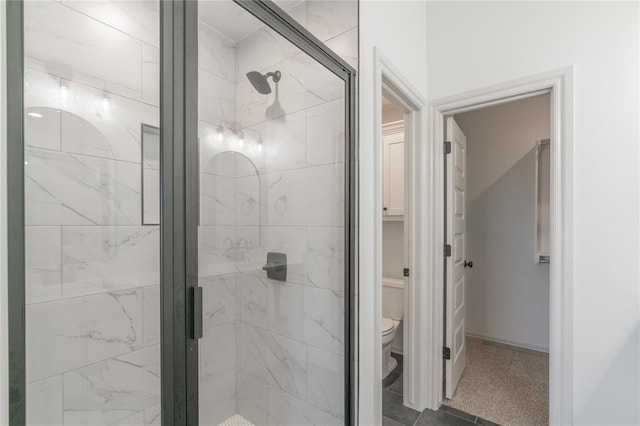 bathroom with a shower stall and toilet