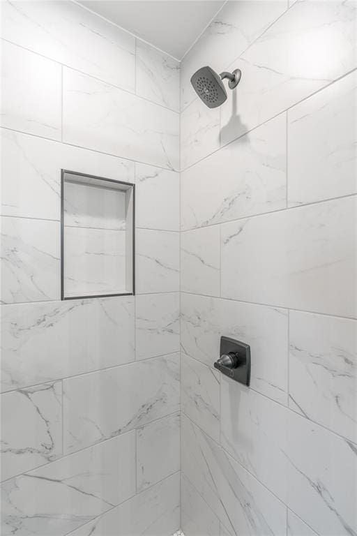 bathroom with tiled shower