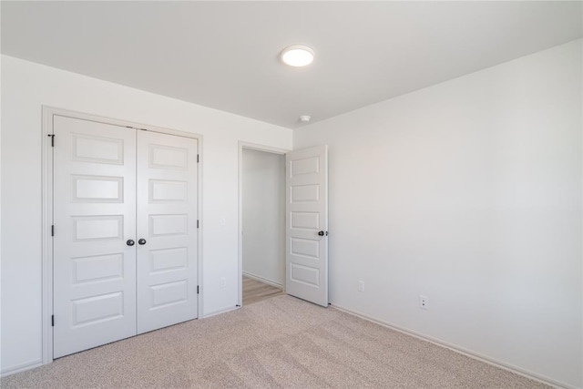 unfurnished bedroom with a closet and carpet flooring