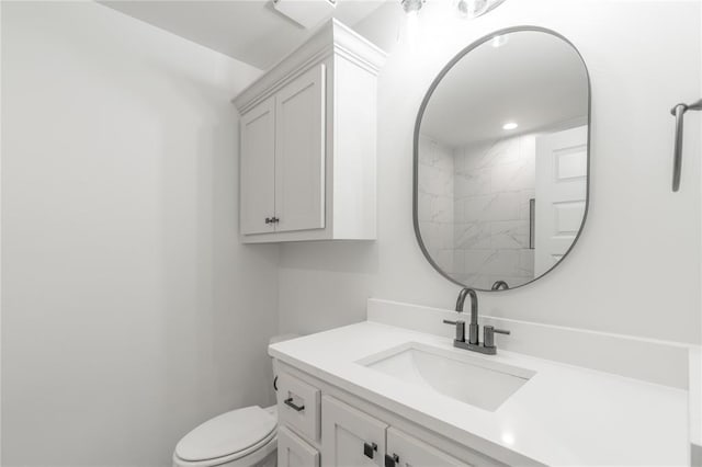 bathroom featuring toilet and vanity