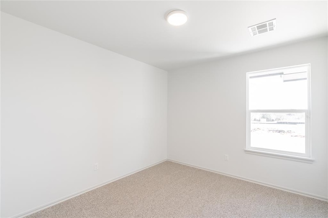 carpeted empty room with baseboards and visible vents