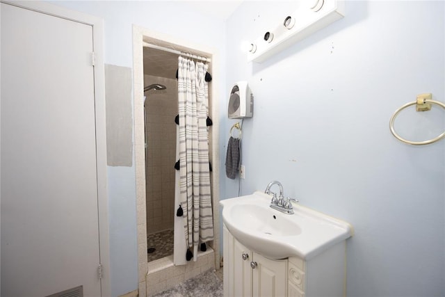 full bathroom featuring a stall shower and vanity