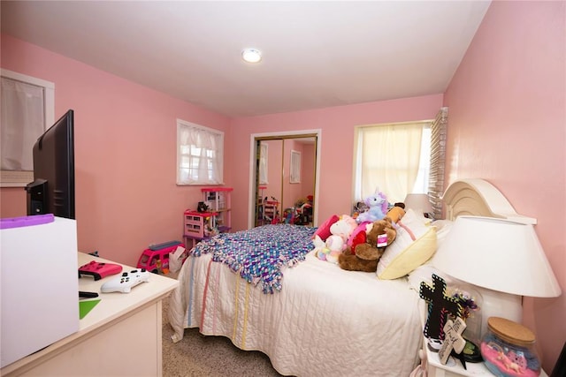 bedroom featuring carpet floors and multiple windows