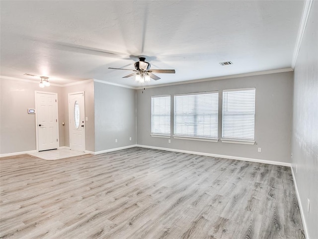 unfurnished room with light wood-style floors, ornamental molding, and baseboards