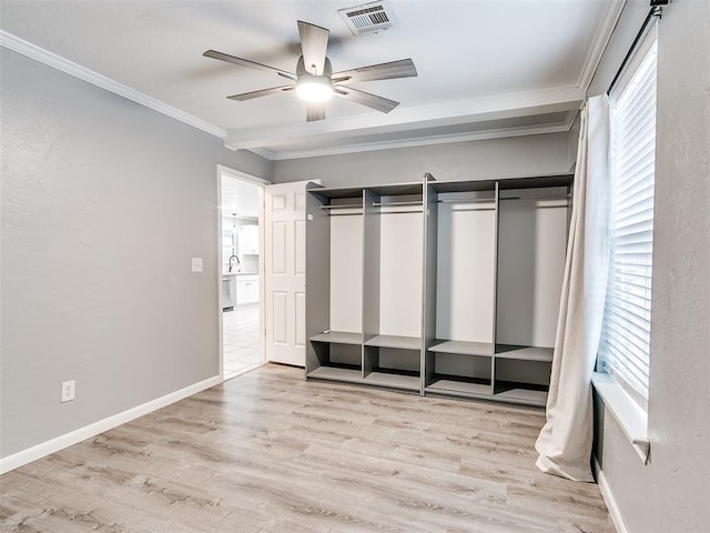 unfurnished bedroom with light wood finished floors, baseboards, visible vents, ceiling fan, and crown molding