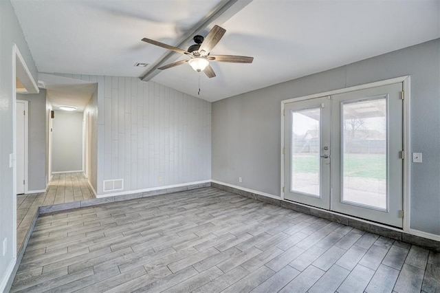 spare room featuring vaulted ceiling with beams, french doors, wood finished floors, and visible vents