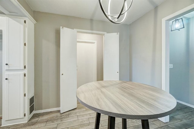 dining room featuring light wood-style floors and baseboards