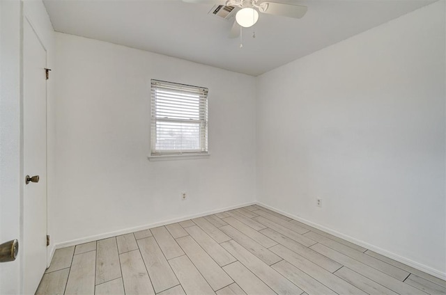 empty room with ceiling fan, light wood-type flooring, visible vents, and baseboards