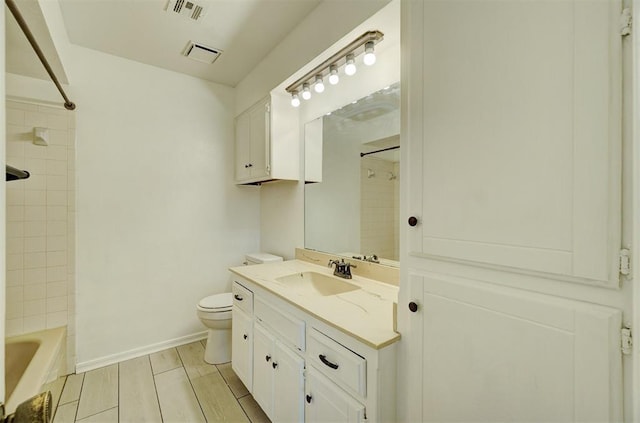 bathroom featuring toilet, visible vents, vanity, baseboards, and wood tiled floor