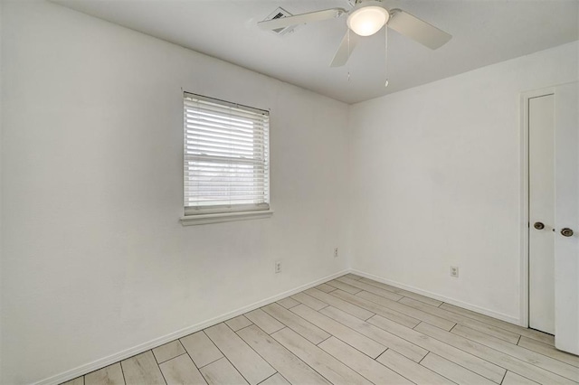 unfurnished room featuring light wood-style floors, ceiling fan, and baseboards