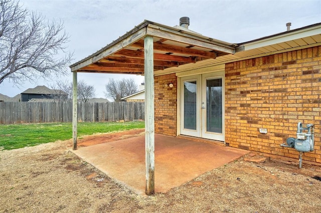 view of patio featuring french doors and fence