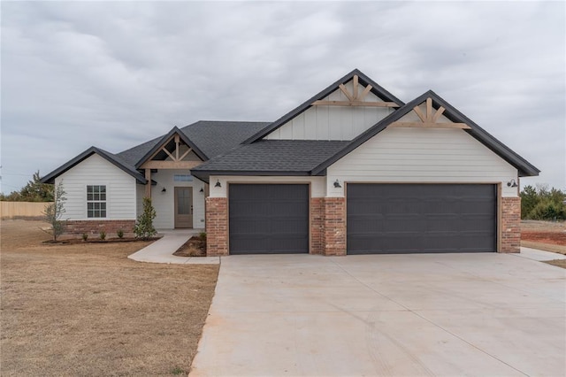 craftsman inspired home featuring a garage, brick siding, a shingled roof, concrete driveway, and board and batten siding