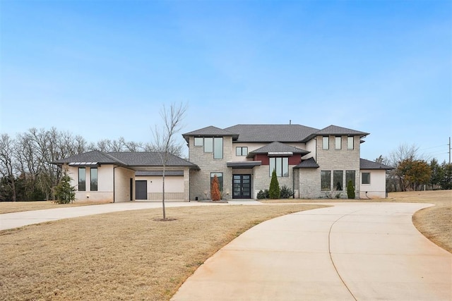 prairie-style home with concrete driveway