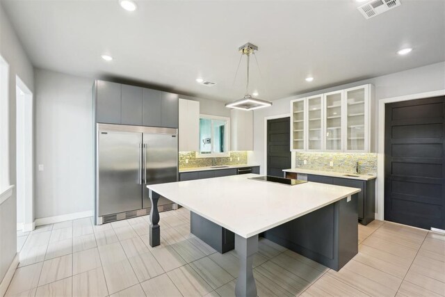 2725 Piazza Ct, Arcadia, OK 73007 - kitchen with built in fridge, tasteful backsplash, a kitchen breakfast bar, a kitchen island, and recessed lighting
