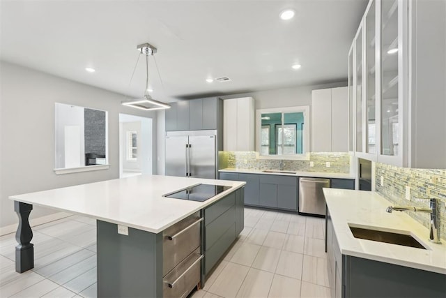2725 Piazza Ct, Arcadia, OK 73007 - kitchen featuring appliances with stainless steel finishes, gray cabinetry, decorative backsplash, a center island, and recessed lighting