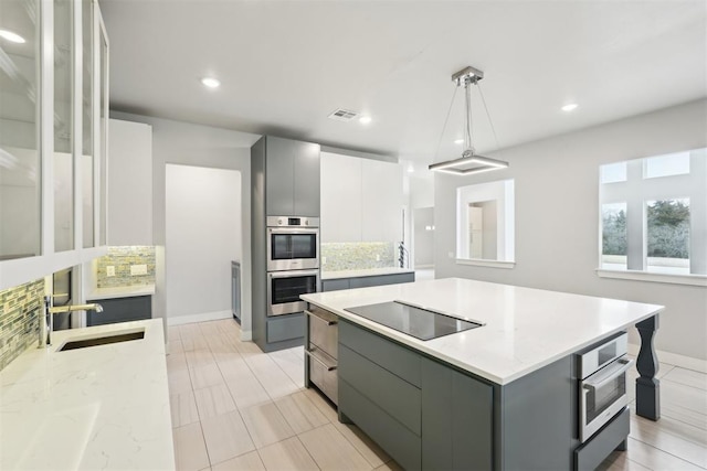 2725 Piazza Ct, Arcadia, OK 73007 - kitchen with black electric stovetop, gray cabinets, stainless steel double oven, and recessed lighting
