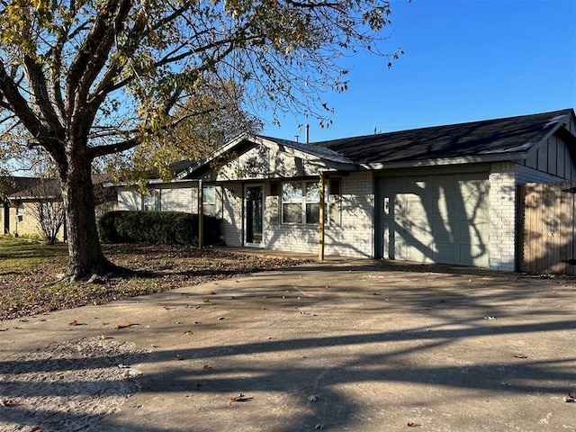 view of front facade featuring a garage, brick siding, and driveway