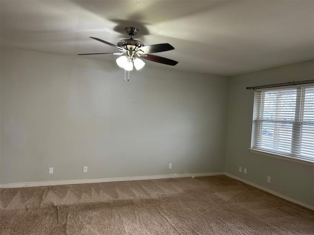 unfurnished room with ceiling fan, baseboards, and carpet flooring