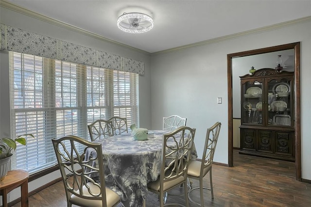 dining area with baseboards, crown molding, and wood finished floors