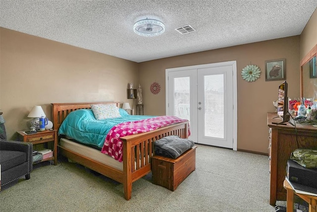 carpeted bedroom with baseboards, visible vents, access to exterior, a textured ceiling, and french doors