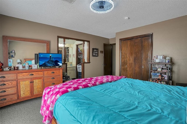 bedroom with a closet, light colored carpet, and a textured ceiling