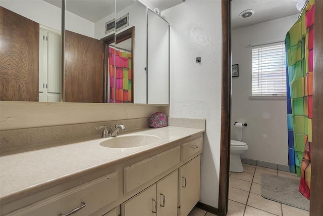 full bathroom with visible vents, toilet, vanity, baseboards, and tile patterned floors