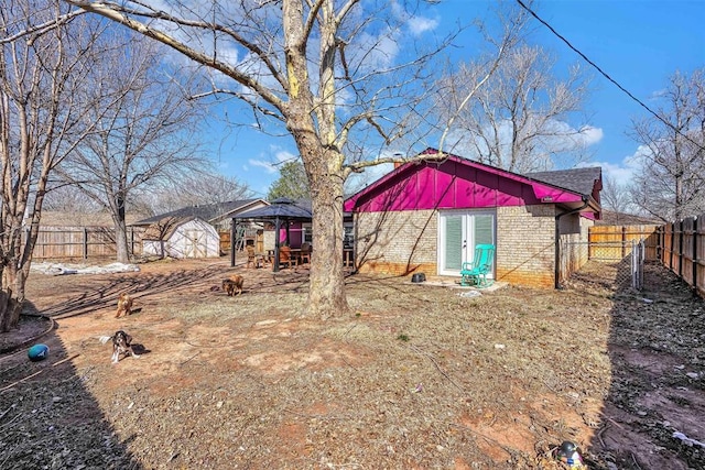 view of yard with a storage unit, fence, and an outbuilding