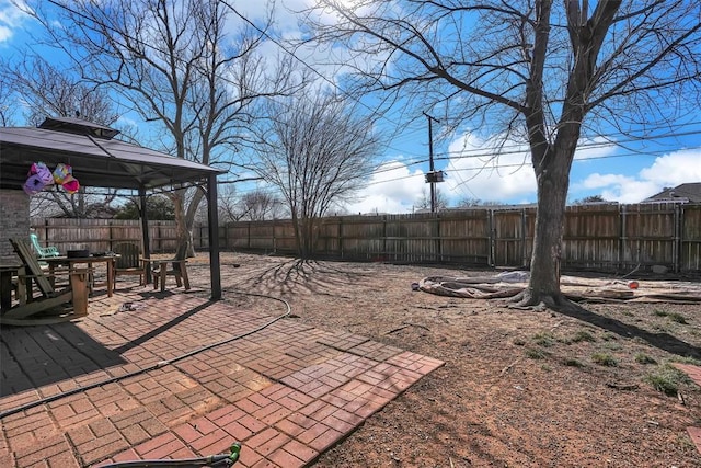 view of yard featuring a patio area, a fenced backyard, and a gazebo