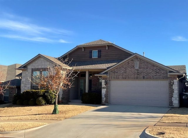 view of front of property featuring brick siding, roof with shingles, an attached garage, stone siding, and driveway