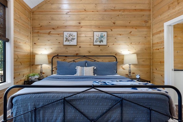 bedroom with wood walls and vaulted ceiling