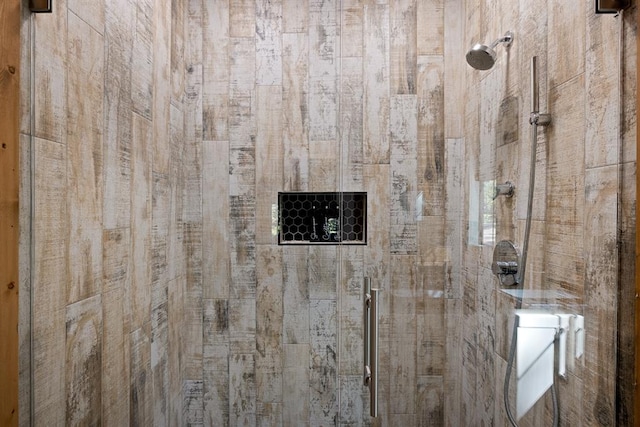 interior details featuring a tile shower