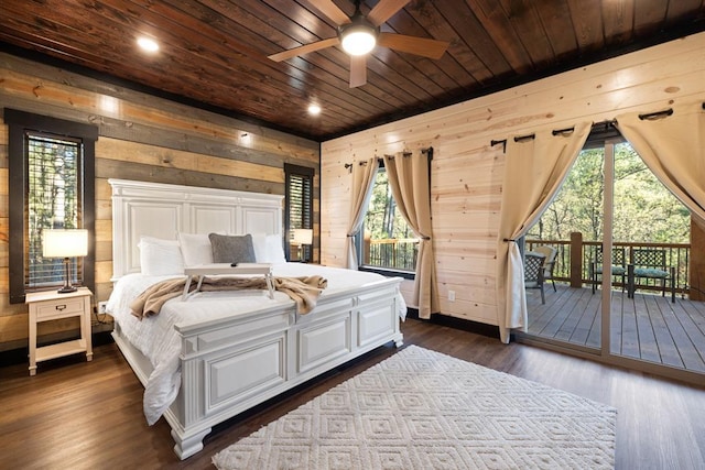 bedroom featuring wooden walls, multiple windows, wooden ceiling, access to outside, and dark wood-style flooring