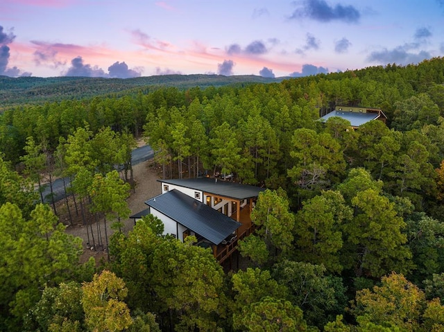 birds eye view of property with a forest view