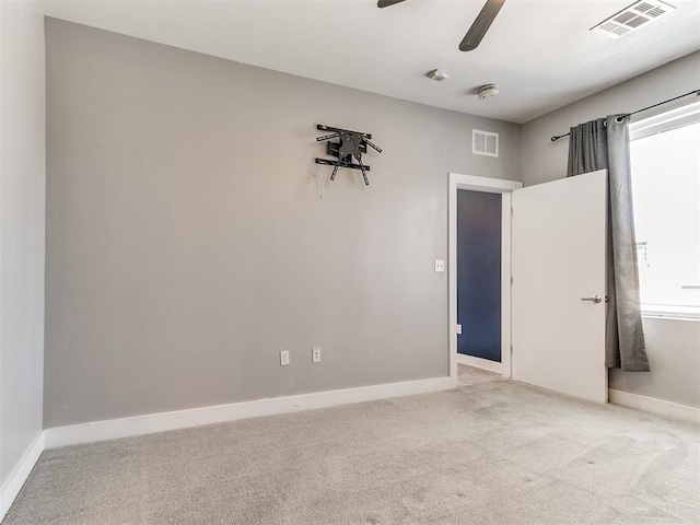 444 N Central Ave Unit 110, Oklahoma City, OK 73104 - unfurnished room with light colored carpet, baseboards, ceiling fan, and a smoke detector