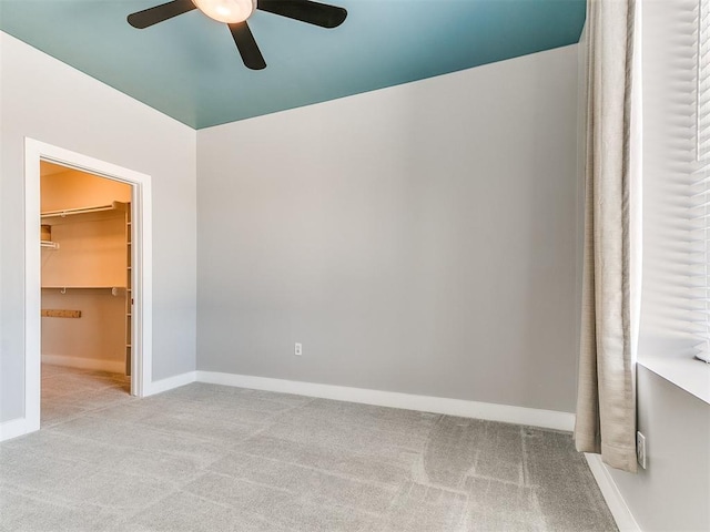 444 N Central Ave Unit 110, Oklahoma City, OK 73104 - unfurnished bedroom with carpet floors, a walk in closet, baseboards, and a ceiling fan