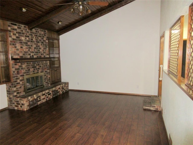 unfurnished living room with wood ceiling, a brick fireplace, dark wood finished floors, and beamed ceiling