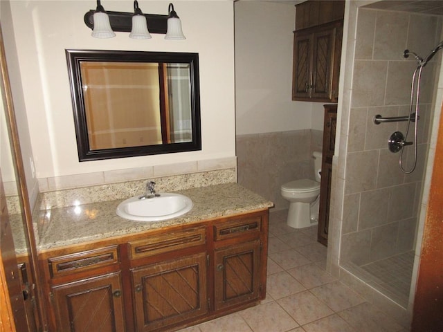 bathroom with toilet, a stall shower, vanity, and tile patterned floors