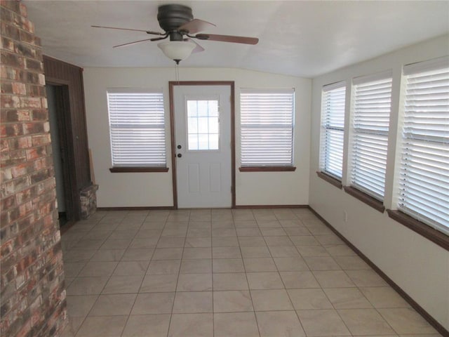 unfurnished sunroom with vaulted ceiling and a ceiling fan