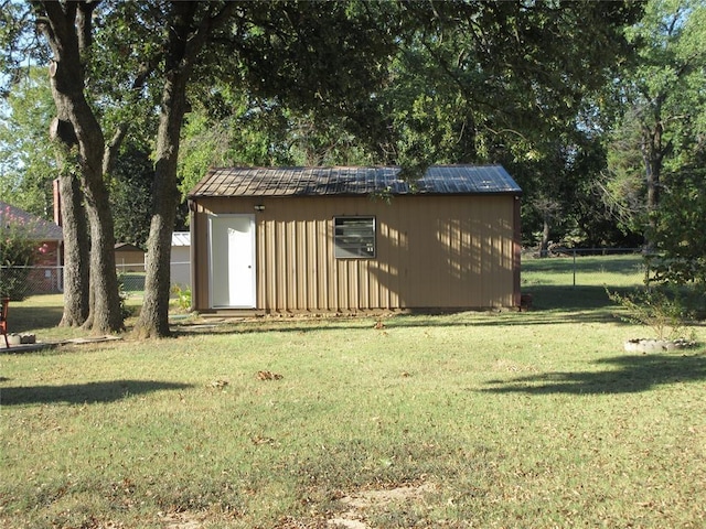 view of shed featuring fence