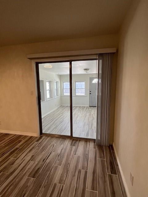 entryway featuring baseboards and wood finished floors