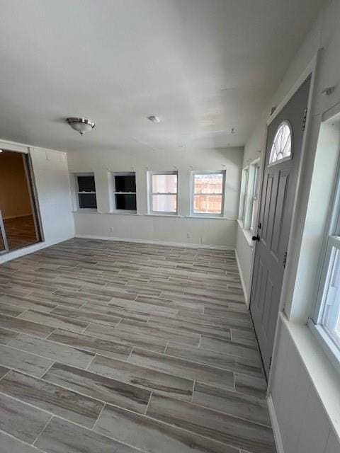 interior space with wood finish floors and baseboards