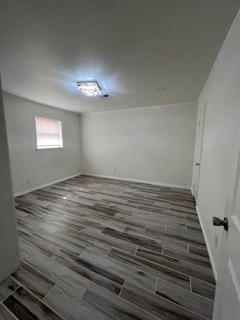 empty room featuring wood tiled floor and baseboards