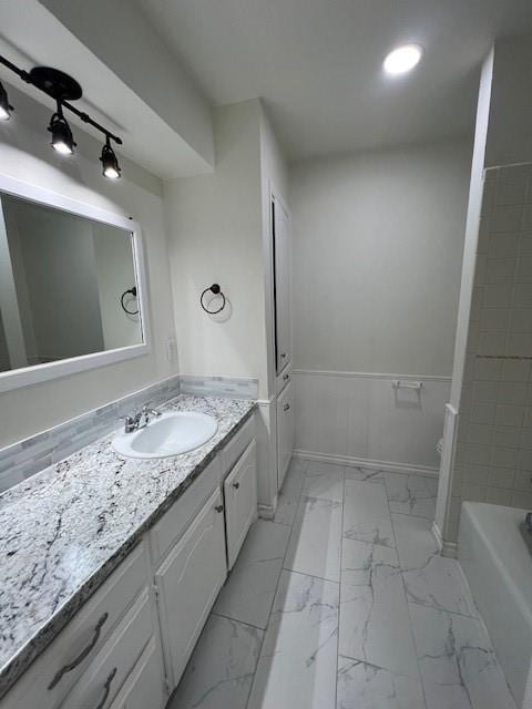 full bath featuring marble finish floor, recessed lighting, and vanity