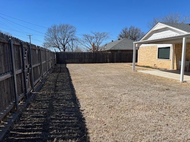 view of yard with a patio area and a fenced backyard