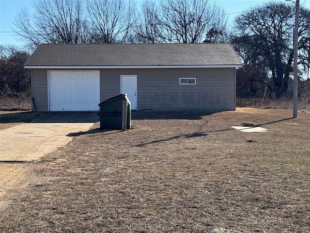 detached garage featuring driveway