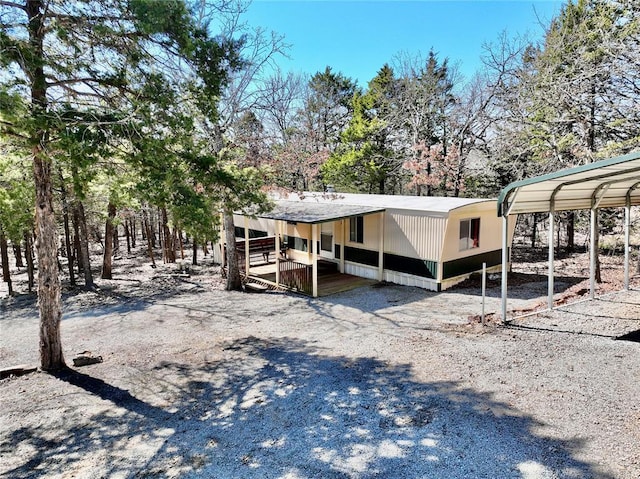 exterior space featuring gravel driveway and a detached carport